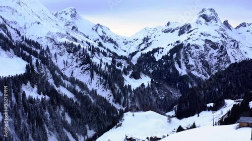 Alps in Austria, Snow covered Rocks with blue sky. Vallay and Mountain view in snowy winter