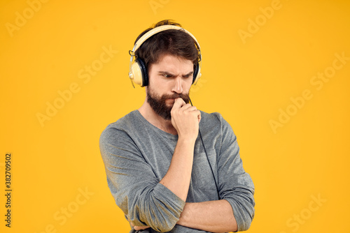 Man with headphones music lifestyle lifestyle technology yellow background © SHOTPRIME STUDIO