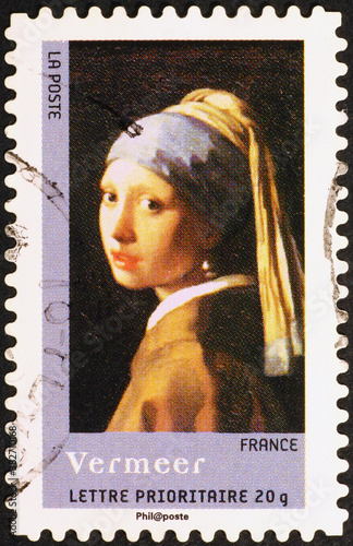 Famous painting by Vermeer on french postage stamp photo