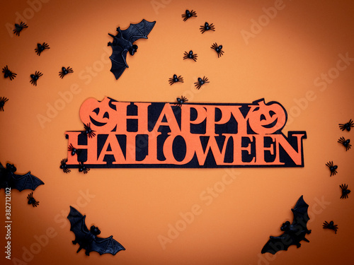 Halloween background. Halloween decorations, spiders, bats, pumpkin, orange background. Happy Halloween!
