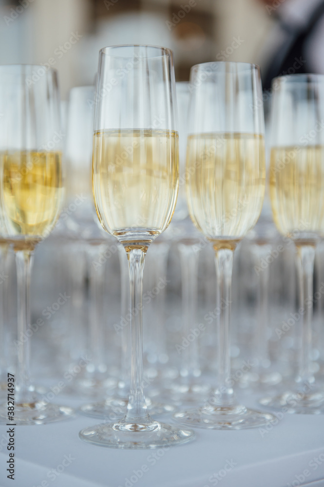 Glasses of champagne at the Banquet, white sparkling wine in wine glasses, festive mood Glasses of champagne at the Banquet, white sparkling wine in wine glasses, festive mood