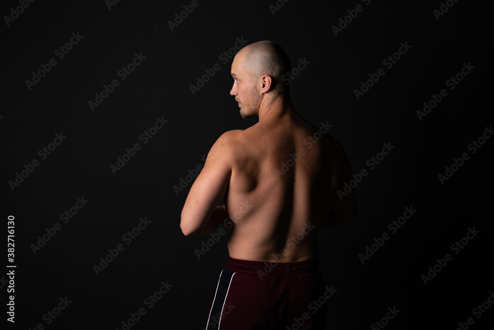 The back of a guy with one light looks towards the Caucasian in training pants The back of a guy with one light looks towards the Caucasian in training pants