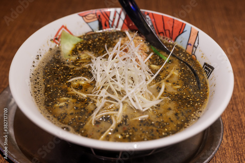 Special Black Tan Tan Ramen, Japanese Spicy  noodles soup with minced pork, black sesame, chili oil and chili bean paste. photo