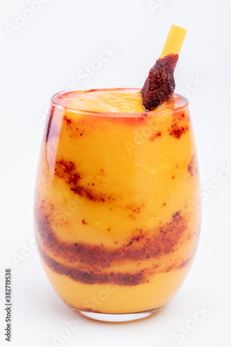 Chamoyada is a smoothie made of mango, chamoy, sugar and ice dressed with a tamarind and chile lollipop.