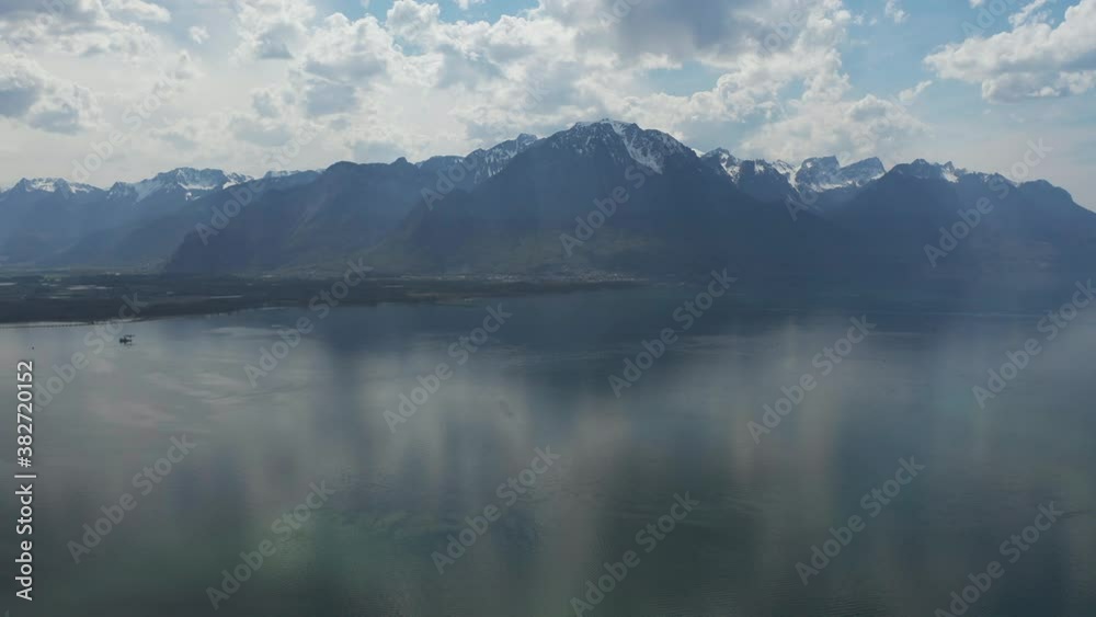 aerial shoot view of the city of Montreux located between the high hills and the lake against the bright blue cloudless sky Switzerland aerial shoot view of the city of Montreux located between the high hills and the lake against the bright blue cloudless sky Switzerland