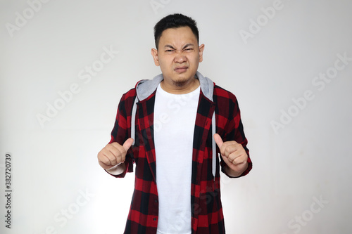 Billede på lærred Asian man pointing himself with unhappy displeased expression as if he confused