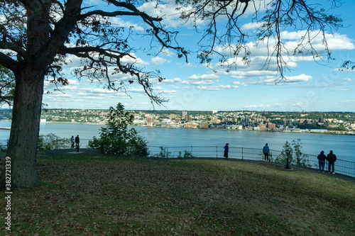 Alpine, NJ / United States - Oct. 3, 2020: a landscape view of tourists enjoying the scenic Alpine Overlook. The overlook offers views of city of Yonkers and the Hudson River.