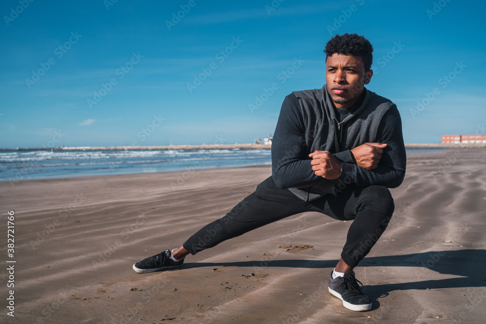 Athletic man stretching legs before exercise. Athletic man stretching legs before exercise.