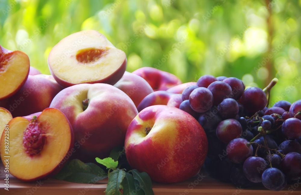 ripe peaches and grapes on wooden table ripe peaches and grapes on wooden table