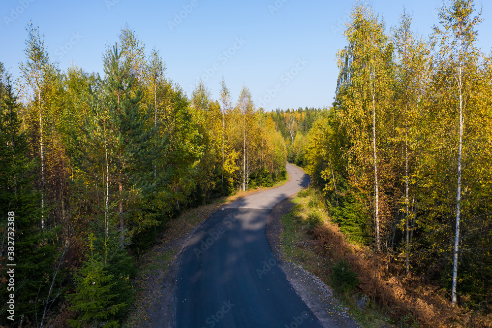 Aerial view of the road in the autumn forest in Karelia