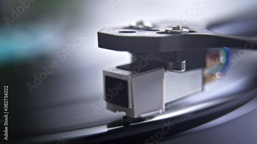 Close up of stylus or needle on turntable with vinyl record spinning