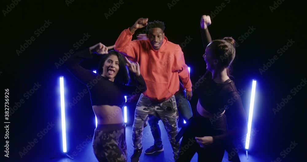 Studio, slow motion, a group of dancers jumping energetically Studio, slow motion, a group of dancers jumping energetically