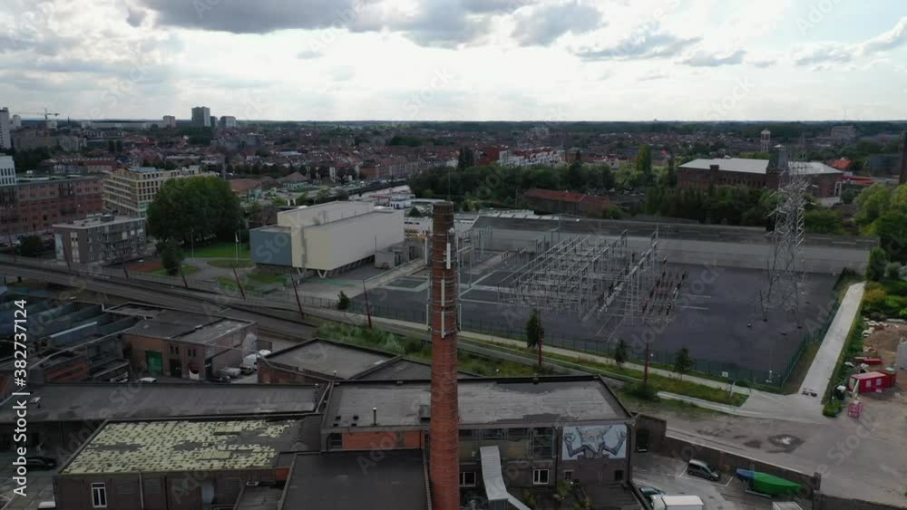 Aerial, pov, an old chimney in an industrial district, Gent, Belgium Aerial, pov, an old chimney in an industrial district, Gent, Belgium