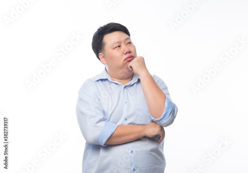 Young Fat Asian business man thinking with doubts face isolated on white background. © Touchr