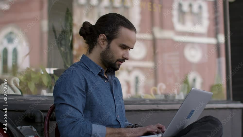 The future of work. Technology worker. Computer programer works outside a remotely creating the next new breakthrough. Shot in 4k. 