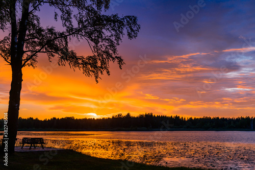 Fantastic landscape at sunset with a stunning forest lake