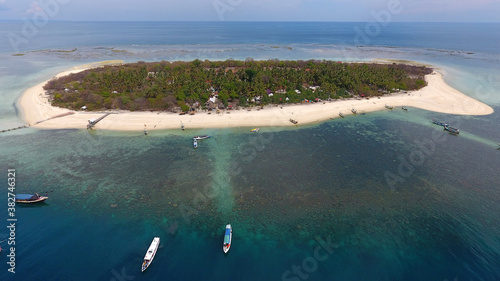 Aerial view of Gili Labak Island in Madura, Indonesia. A tourist paradise with beautiful white sand surrounding the island as large as a soccer field photo