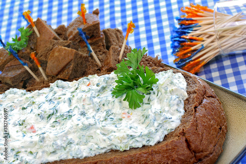 Macro of spinach dip in hollowed loaf of pumpernickel bread.