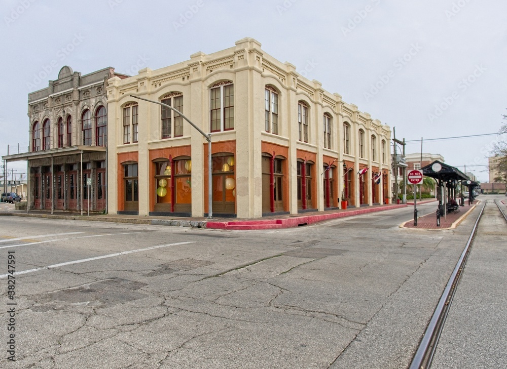 Trolly stop, historic buildings, and wide street corner in downtown Galveston Island, Texas