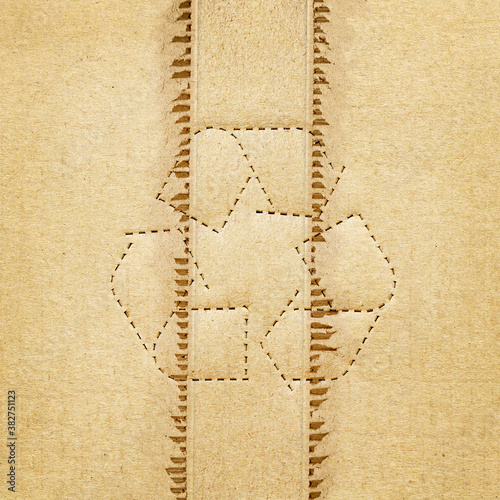 Brown corrugated or cardboard sheet texture paper torn with recycle symbol background
