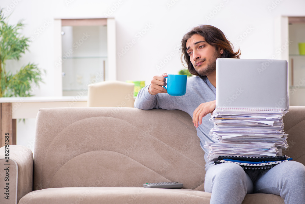 Young male employee freelancer working from home Young male employee freelancer working from home