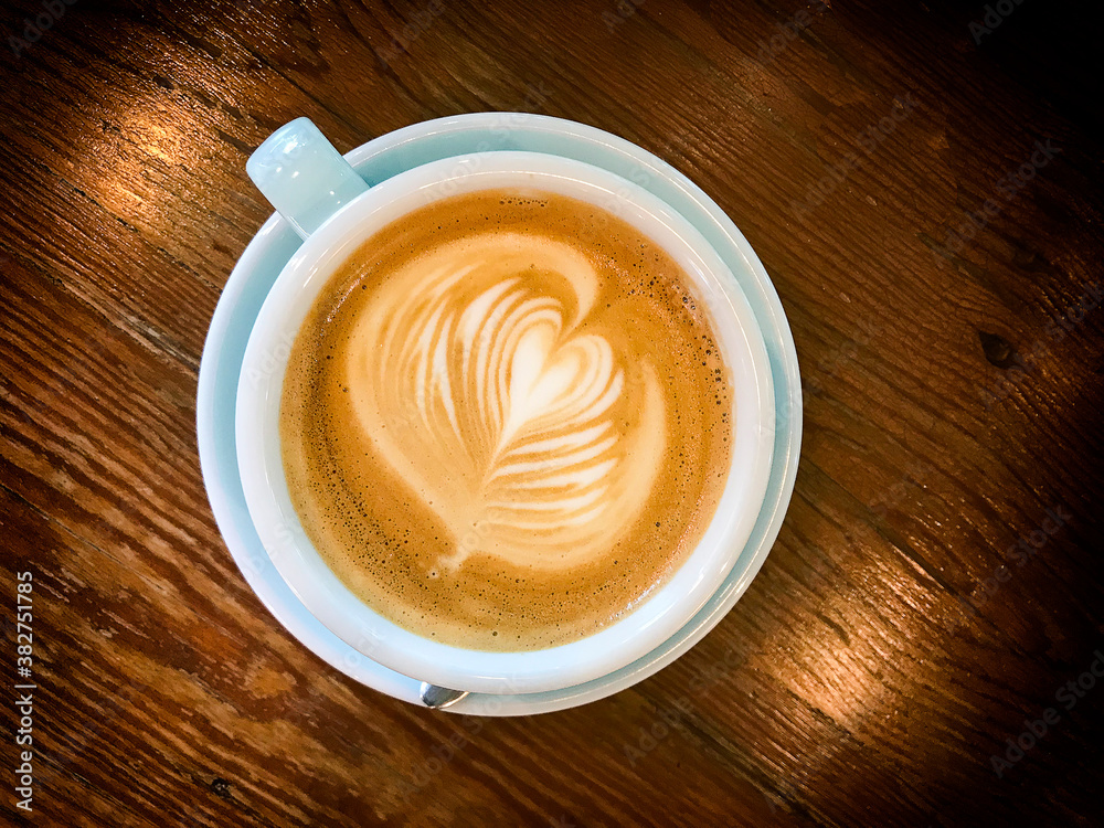 top view of coffee in ceramic cup put on a wooden table top view of coffee in ceramic cup put on a wooden table