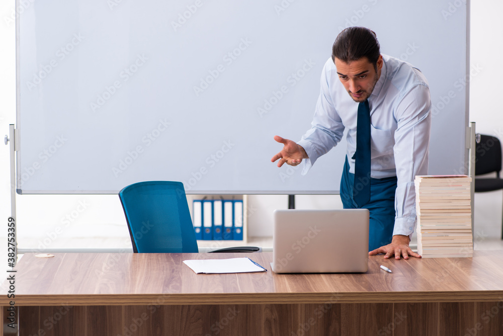 Young male employee in business presentation concept