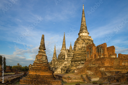 Ruins of the ancient Buddhist temple of  Wat Phra Sri Sanphet close up on a sunny morning. Ayutthaya, Thailand © sikaraha