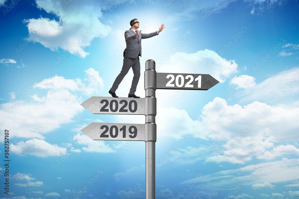 Road sign and businessman with 2020 and 2021 Road sign and businessman with 2020 and 2021