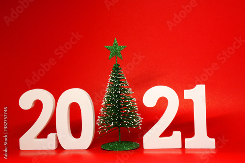 2021 number wooden with xmas tree or christmas tree object on red background - Happy new year 2021 , xmas celebration - Countdown celebrate red concept 