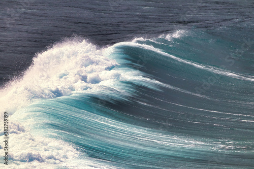 Power of a crashing azure wave breaking at honolua bay on Maui.