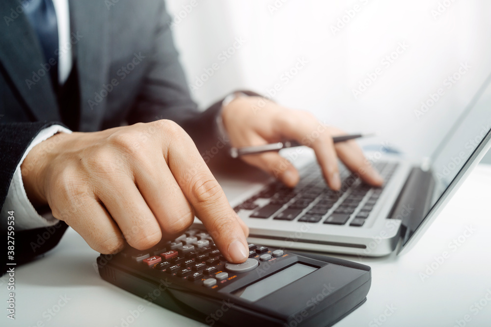 Business people use tablets and hold credit cards as an online shopping concept With a calculator and a book placed on the table Business people use tablets and hold credit cards as an online shopping concept With a calculator and a book placed on the table