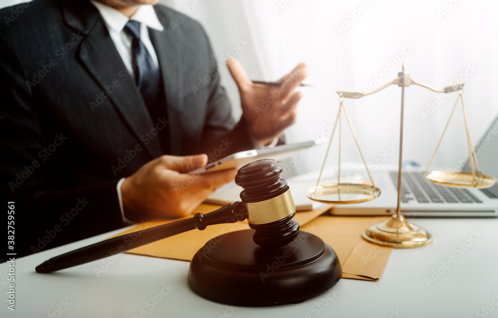 justice and law concept.Male judge in a courtroom on wooden table and Counselor or Male lawyer working in office. Legal law, advice and justice concept. justice and law concept.Male judge in a courtroom on wooden table and Counselor or Male lawyer working in office. Legal law, advice and justice concept.
