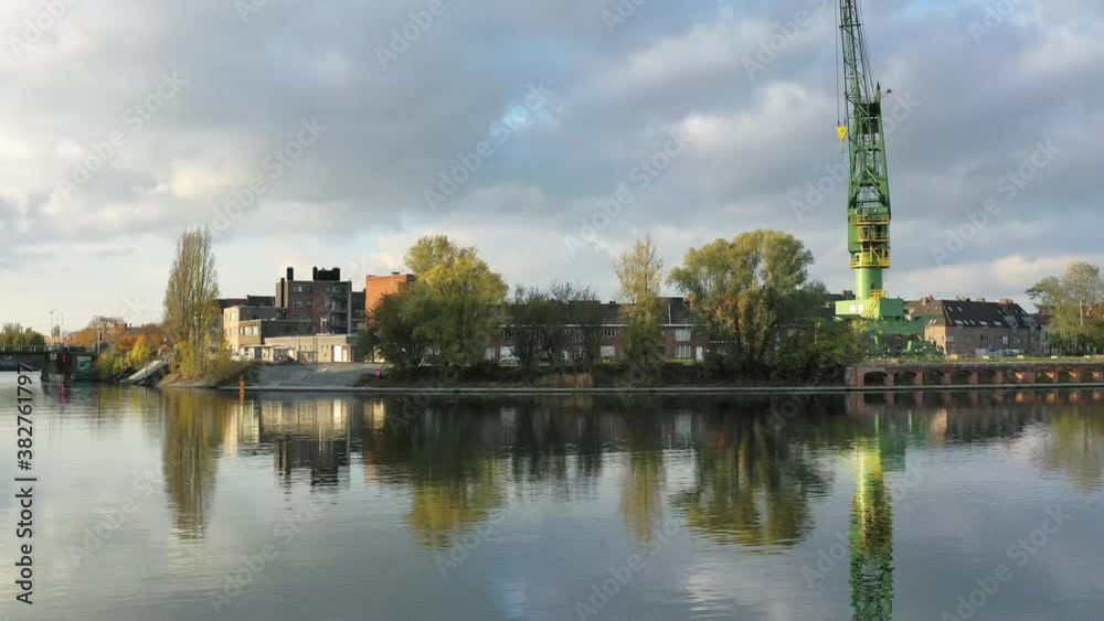 Aerial, panning, cityscape with a canal in golden sunlight, Gent, Belgium Aerial, panning, cityscape with a canal in golden sunlight, Gent, Belgium