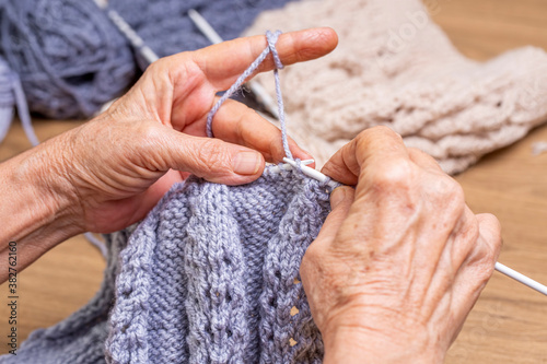 Old woman's hands are knitting