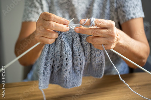 Old woman's hands are knitting