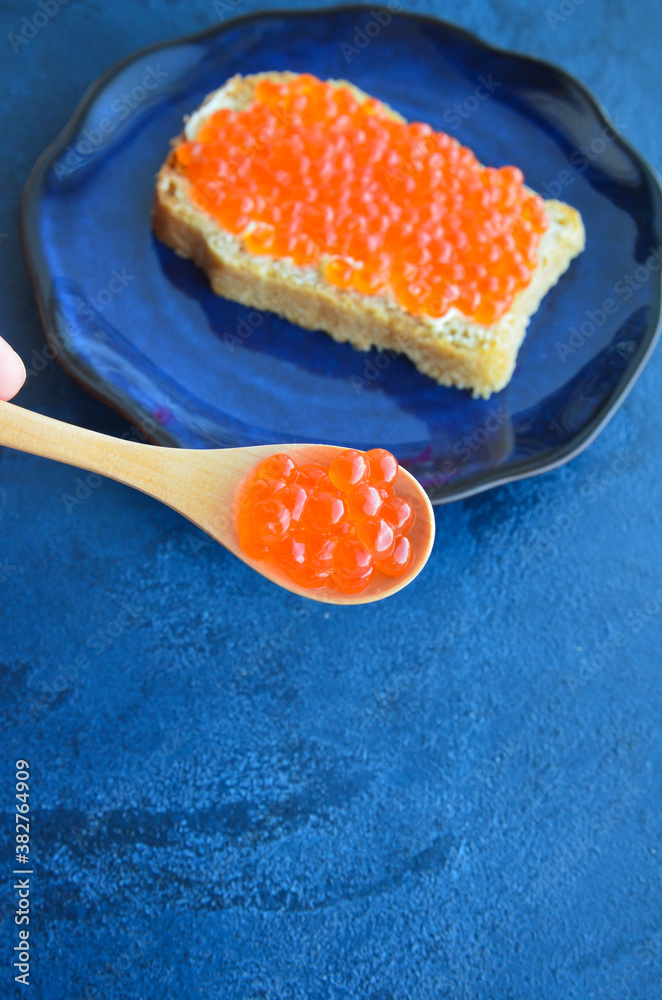 Sandwich with red salmon caviar. Healthy and satisfying natural food