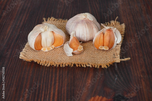 White garlic is a Thai herb and is a spice on a close-up wooden table.