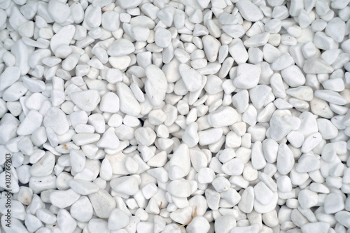 Small naturally polished white rock pebbles background