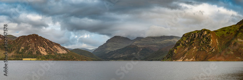 Stunning landscape image looking across Ennerdale Water in the English Lake District towards the peaks of Scoat Fell and Pillar during a glorious Summer sunset photo