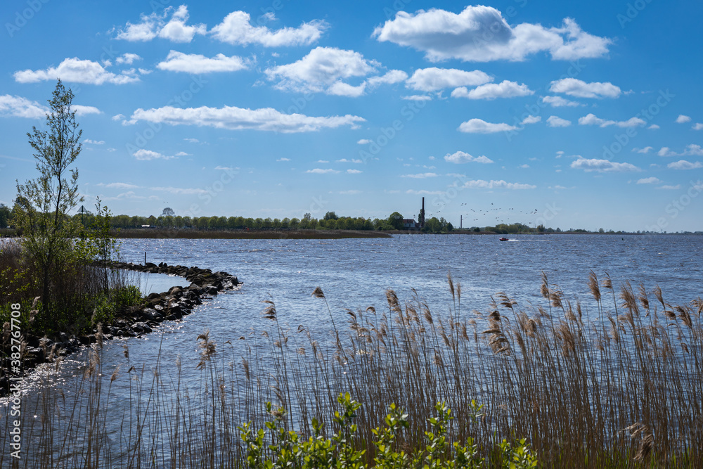 Dutch landscape with water and clouds in summer