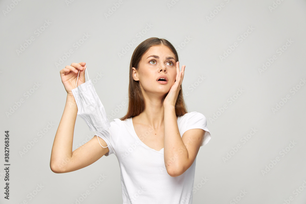 woman looking up medical mask in hand protection woman looking up medical mask in hand protection