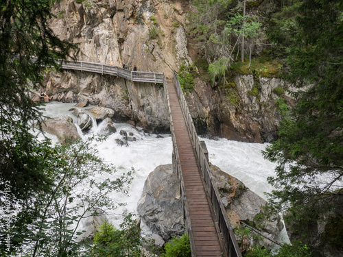 View of Weller Bridge over the Oetztaler Ache River, near Oetz, Tyrol, Austria photo