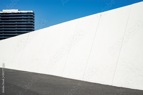 Urban landscape with white wide wall. Copy space for text or design