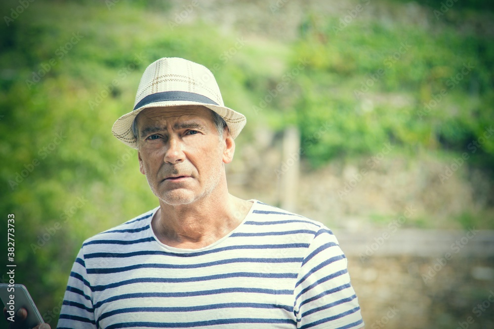 tourist with hat and mobile phone in the field tourist with hat and mobile phone in the field