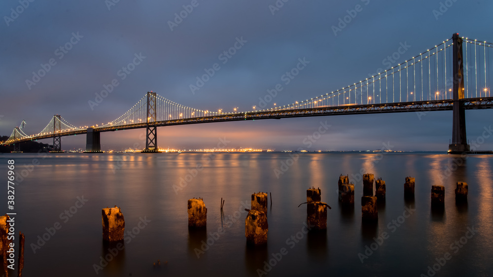 Fototapeta premium Panoramic view of San Francisco Bay bridge at night, California, United States
