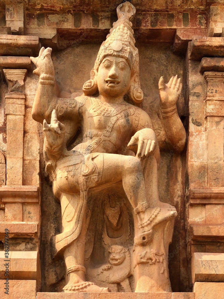 Sculpture of a Hindu God carved in the walls of the  ancient Brihadeeshwarar temple in Thanjavur, Tamilnadu. Statue of Hindu Gods in ancient temples.