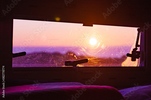 View from caravan inside on sunrise landscape