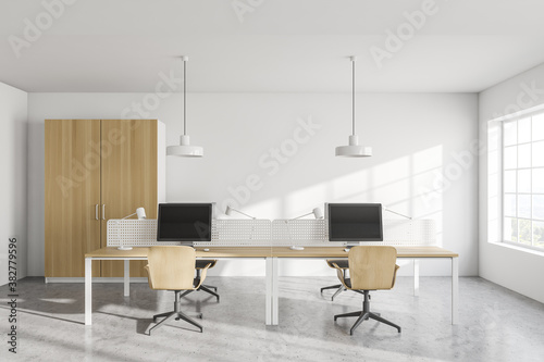 Modern white open space office interior with wooden tables and wardrobe © ImageFlow