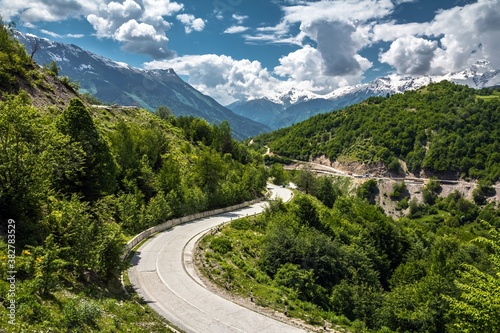 View on an empty asphalt road in the mountains covered with green trees in Svaneti region, Georgia.